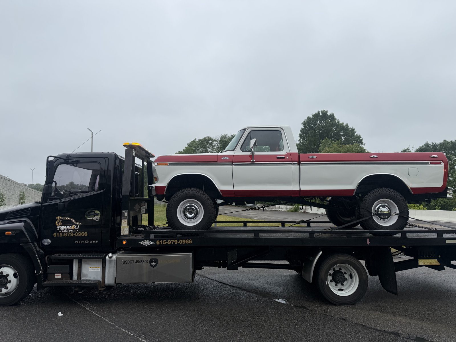 TOW4U flatbed tow truck hauling a classic Ford F-250 pickup in Middle Tennessee